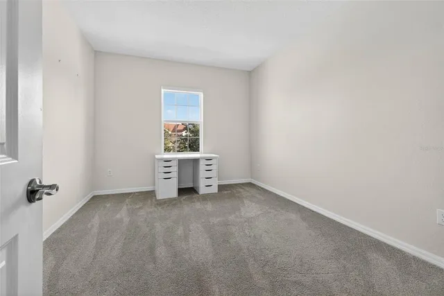 a view of an empty room and a bathroom