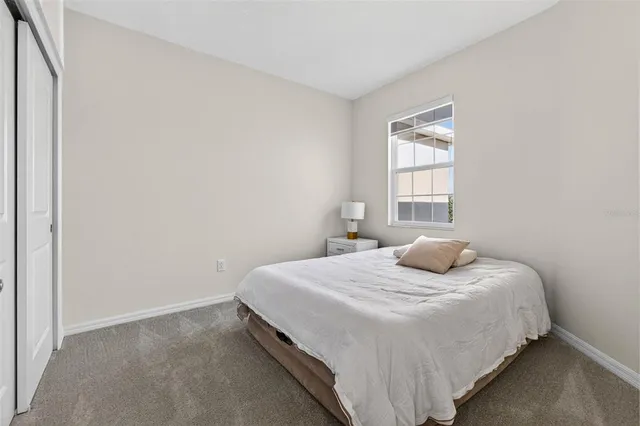 a bedroom with a bed and window