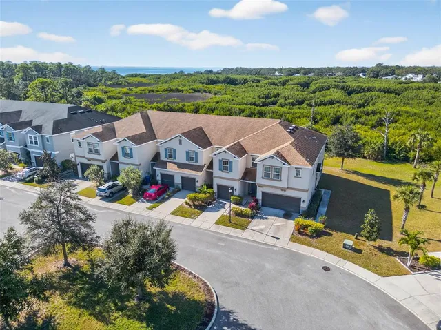 an aerial view of a house with garden space and ocean view