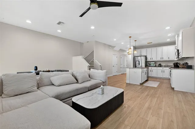 a living room with furniture and kitchen view