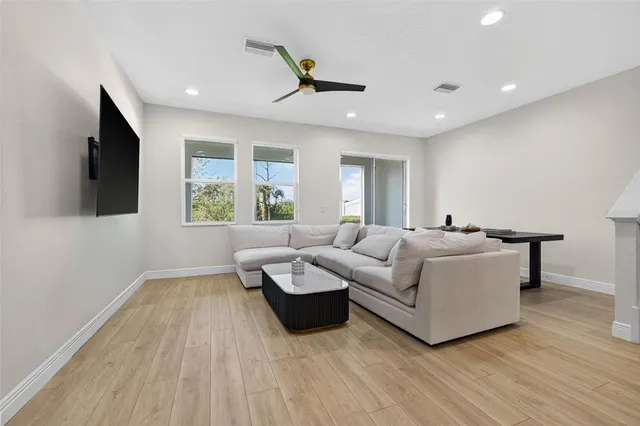 a living room with couches and a flat screen tv