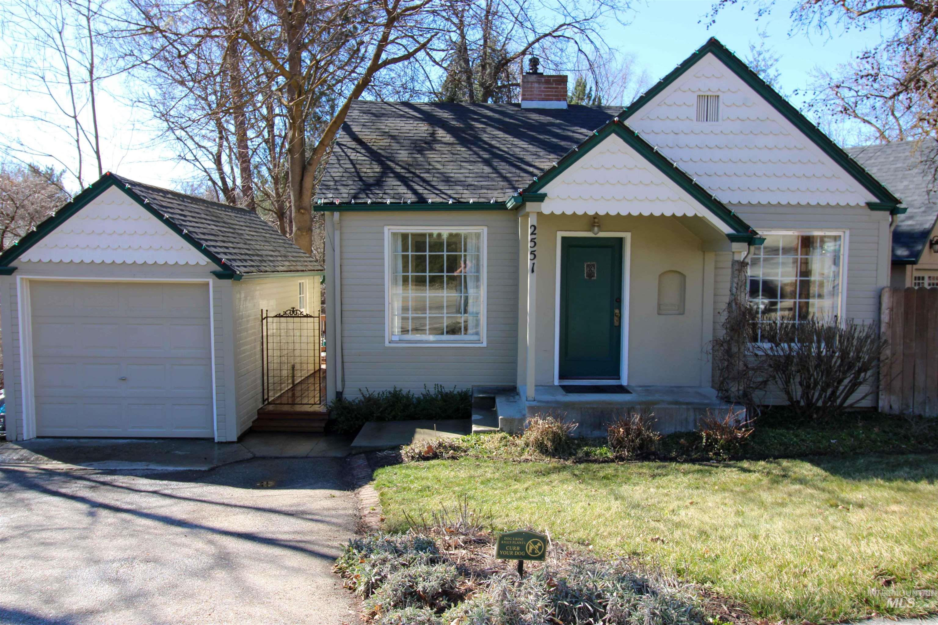 2551 West Hill Road Boise, ID 83702 - Photo 1 of 24 View of front of home with a detached garage, driveway, and a chimney