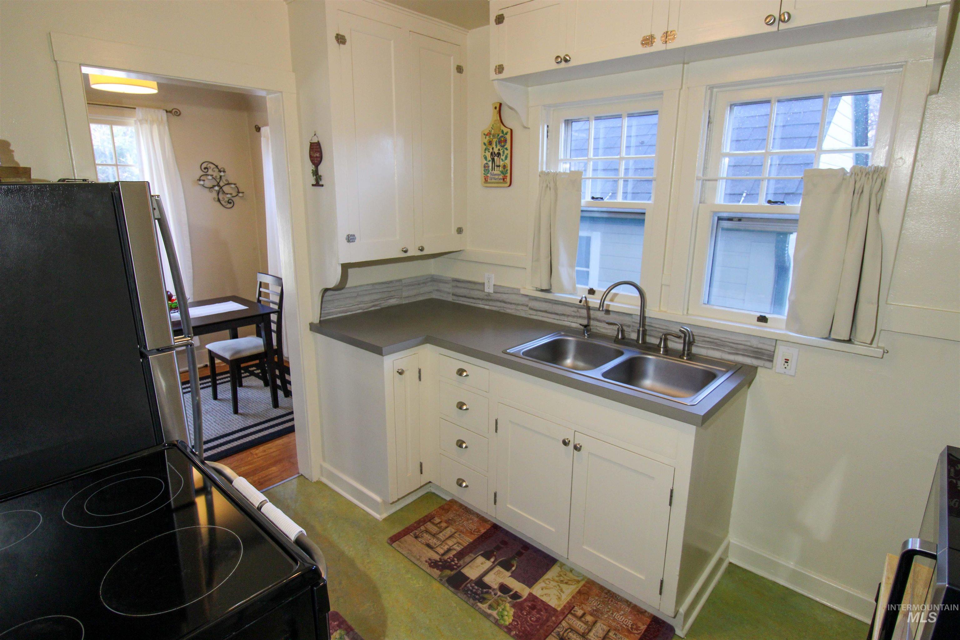 2551 West Hill Road Boise, ID 83702 - Photo 11 of 24 Kitchen featuring stainless steel appliances and white cabinets