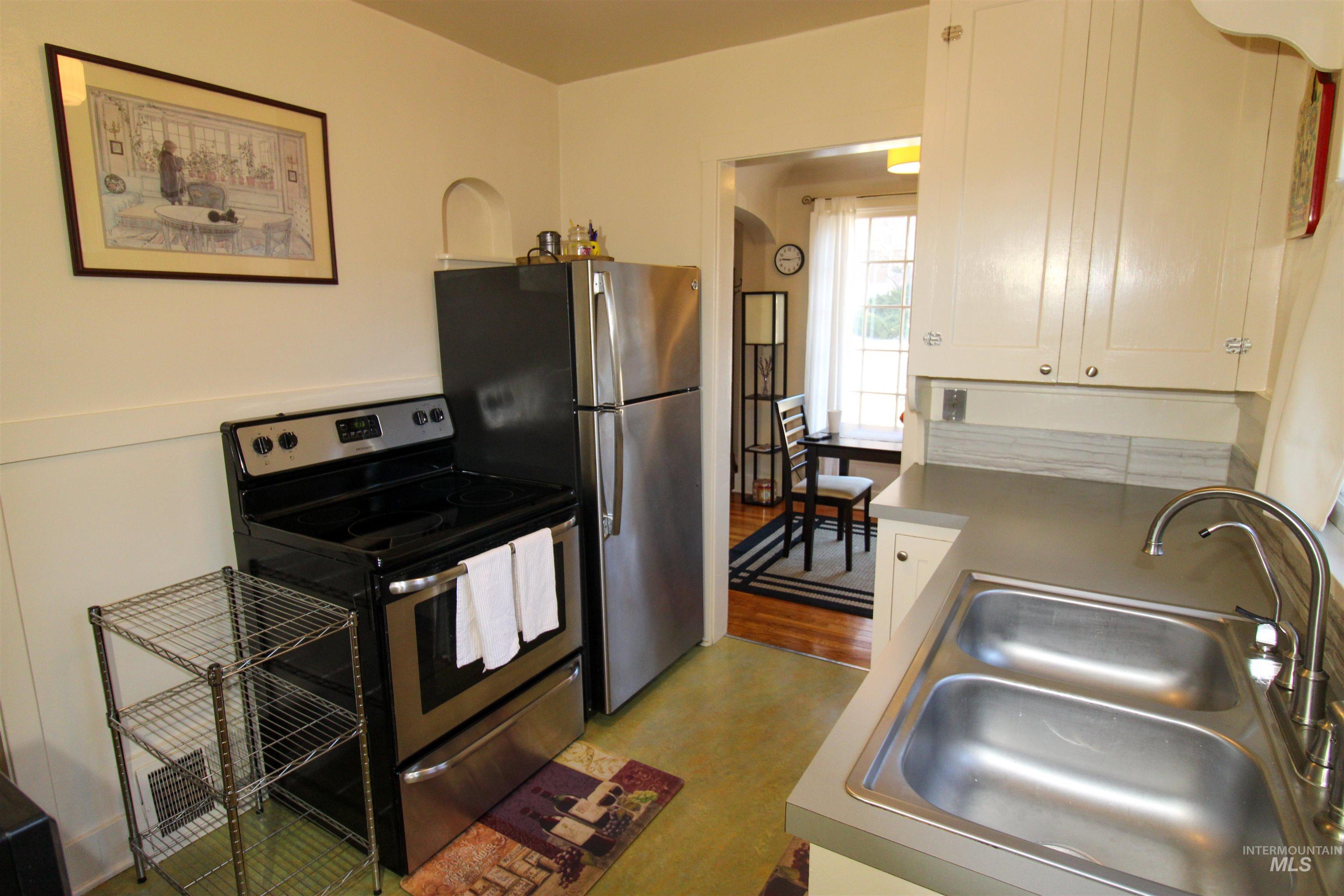 2551 West Hill Road Boise, ID 83702 - Photo 12 of 24 Kitchen with stainless steel electric range oven and white cabinets