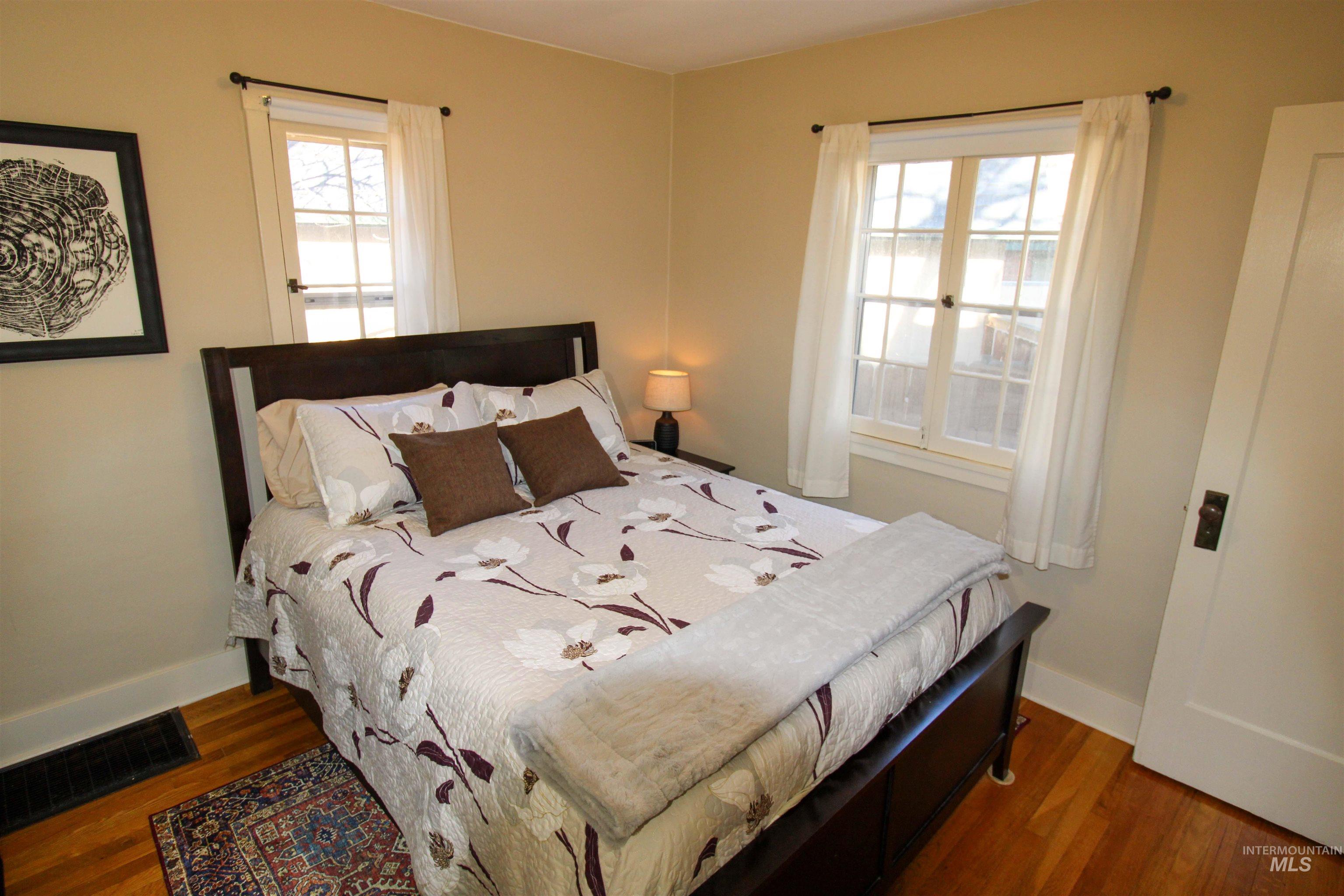 2551 West Hill Road Boise, ID 83702 - Photo 17 of 24 Bedroom with dark wood-style flooring and baseboards