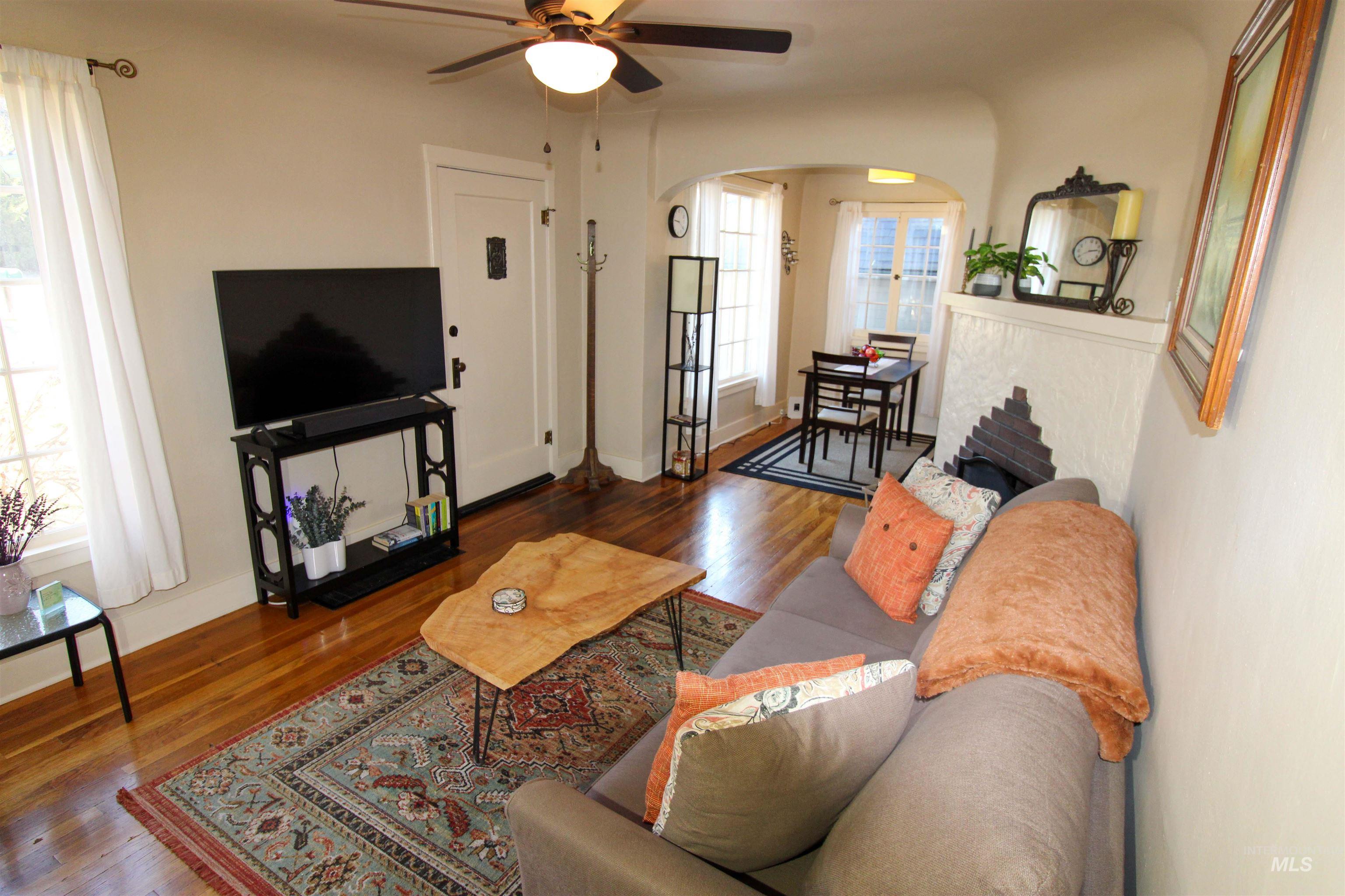 2551 West Hill Road Boise, ID 83702 - Photo 6 of 24 Living room featuring wood finished floors, ceiling fan, and arched walkways