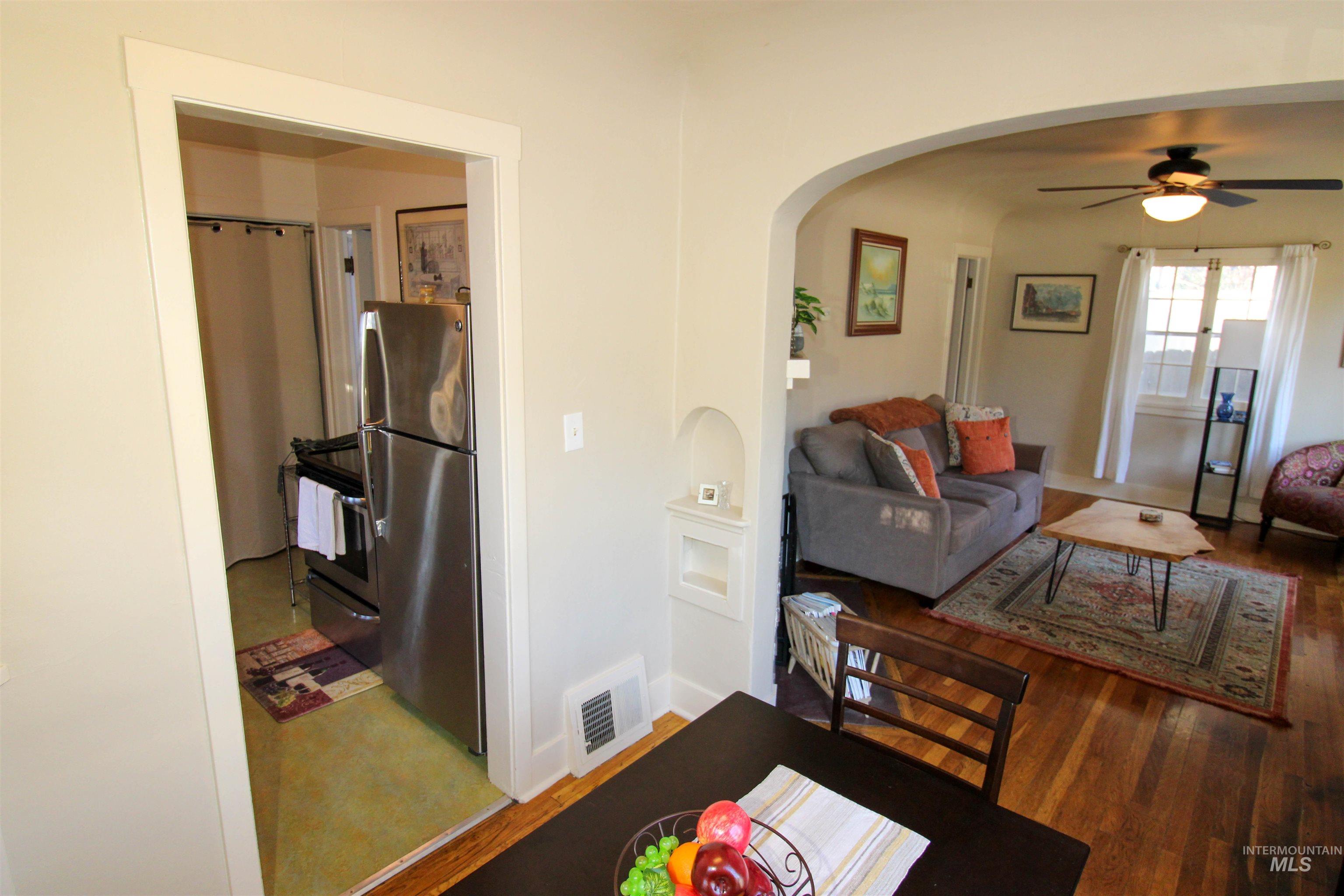 2551 West Hill Road Boise, ID 83702 - Photo 10 of 24 Dining room featuring ceiling fan, wood finished floors, and arched walkways