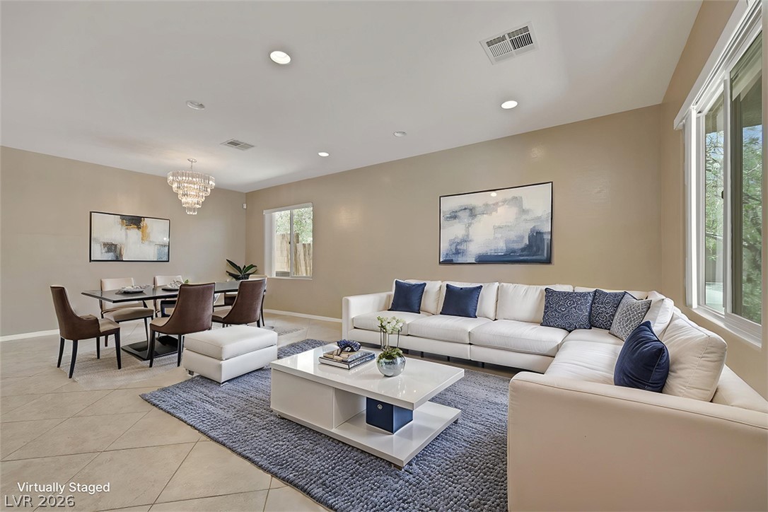 2501 Bechamel Place Henderson, NV 89044 - Photo 48 of 50 An open floorplan seamlessly connects the well-lit dining area with the generous living room.