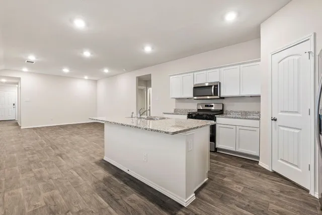 a kitchen with a sink microwave and refrigerator