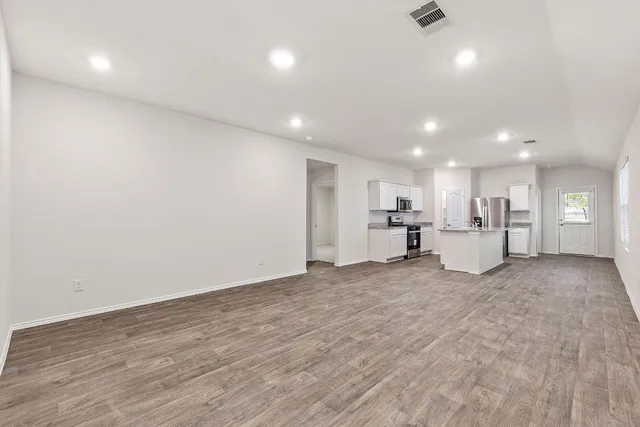 a view of kitchen with a sink and dishwasher a refrigerator with white cabinets