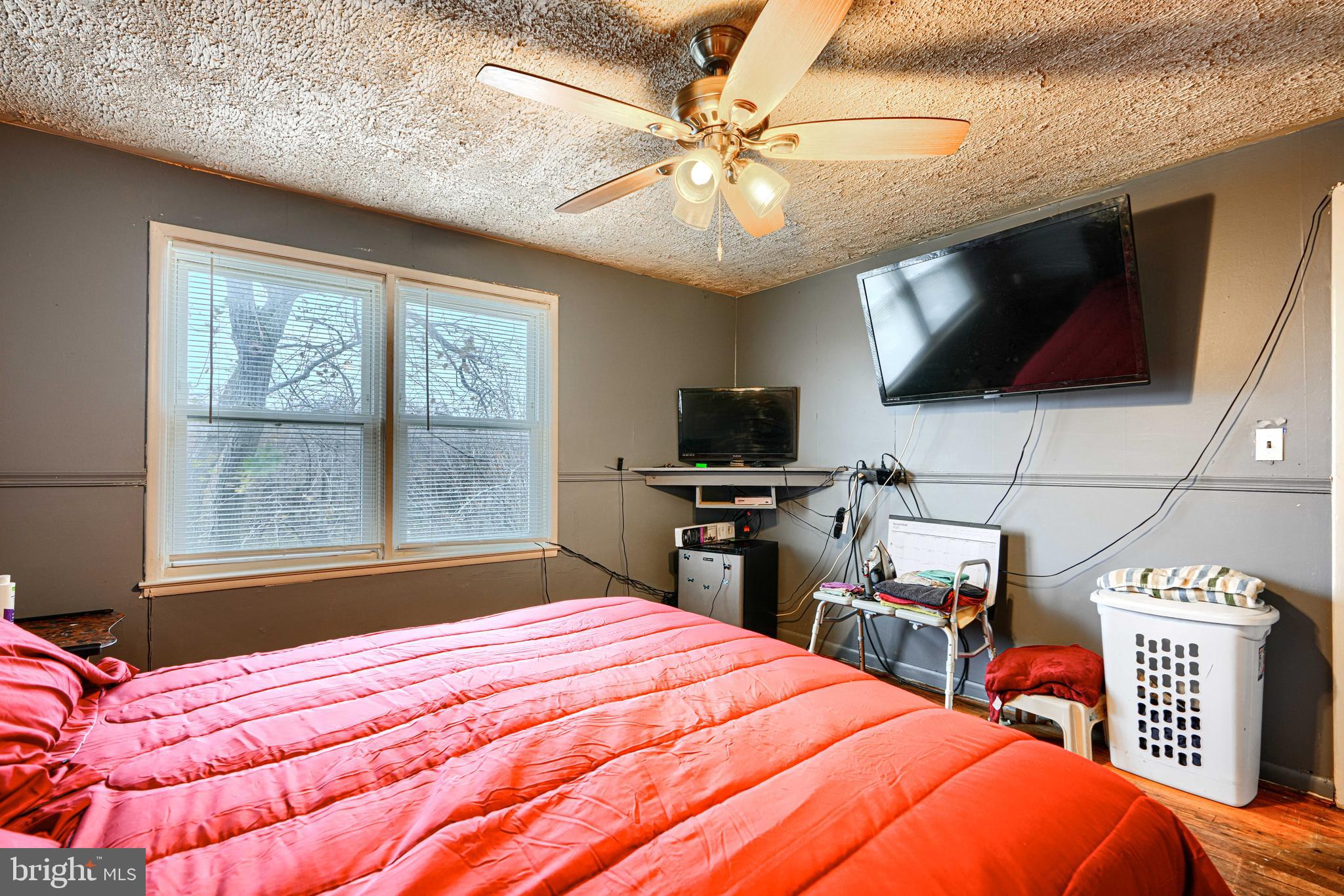 5552 Whitby Road Baltimore, MD 21206 - Photo 12 of 29 a bedroom with a bed and a flat screen tv
