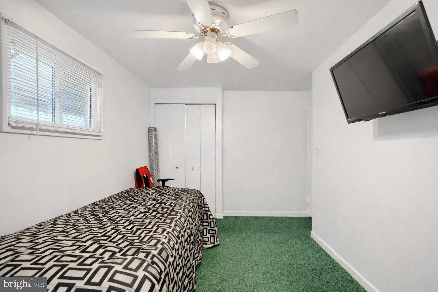 5552 Whitby Road Baltimore, MD 21206 - Photo 15 of 29 a bedroom with a bed and a flat screen tv