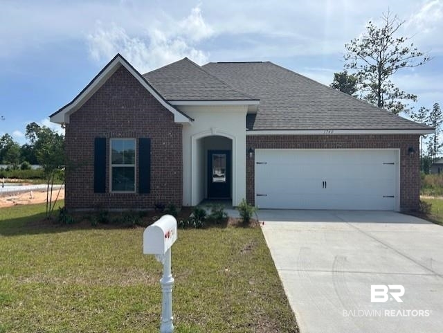 1740 Breckinridge Place Foley, AL 36535 - Photo 1 of 3 View of front of home with brick siding, an attached garage, a front lawn, concrete driveway, and a shingled roof
