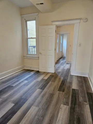 a view of a room with wooden floor