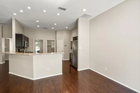 a view of kitchen with stainless steel appliances refrigerator microwave and stove