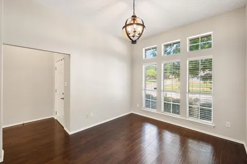 a view of a livingroom with wooden floor and window