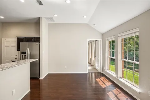 a view of a kitchen with a sink and a large window
