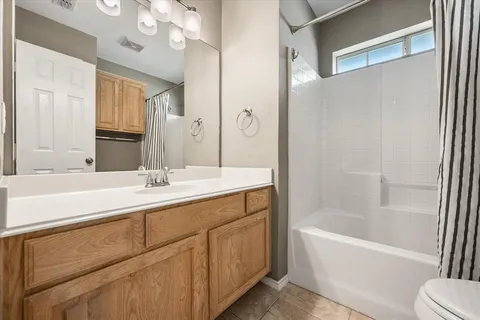 a bathroom with a tub sink and mirror