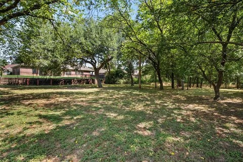 a front view of a house with a big yard