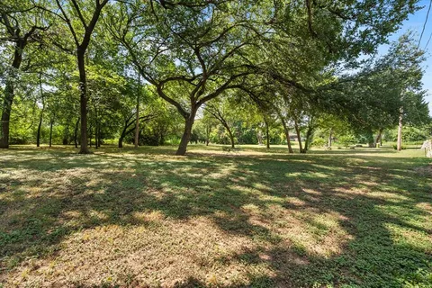 a view of outdoor space with trees all around