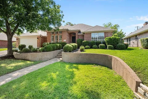 a view of a house with a yard and a patio