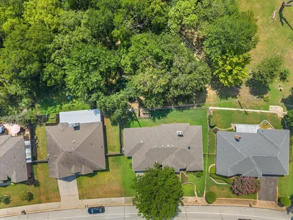 an aerial view of a house with a garden space and lake view