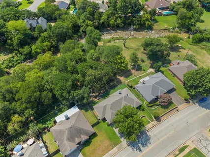 an aerial view of multiple houses with yard