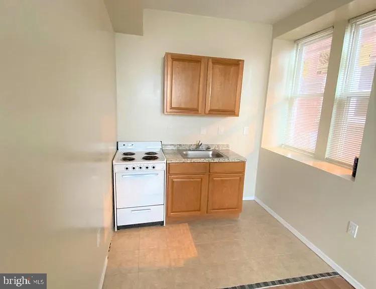 4726 Chestnut Street, Unit 2 Philadelphia, PA 19139 - Photo 2 of 3 a room with a stove top oven and sink