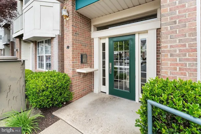 a view of a brick house with large windows