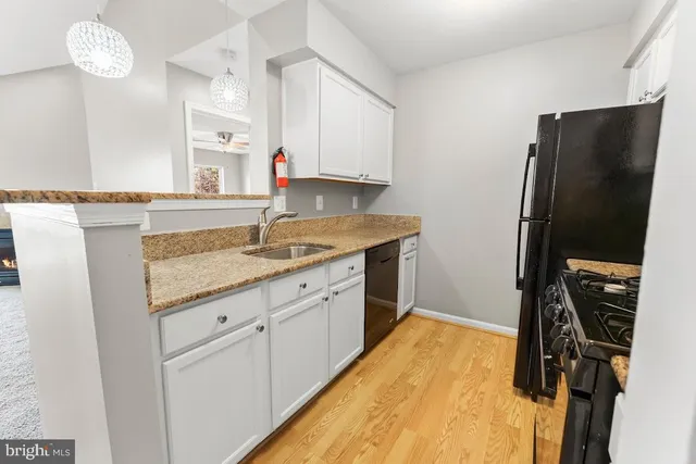 a kitchen with a sink appliances and cabinets