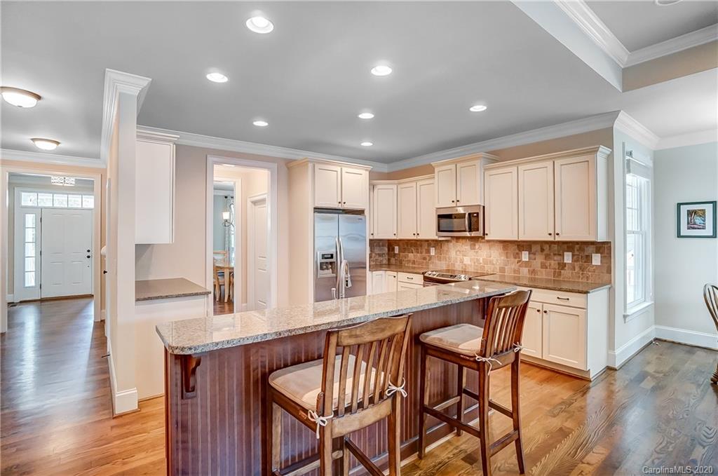 694 Revival Row Fort Mill, SC 29708 - Photo 11 of 46 a kitchen with stainless steel appliances granite countertop a kitchen island hardwood floor and a sink