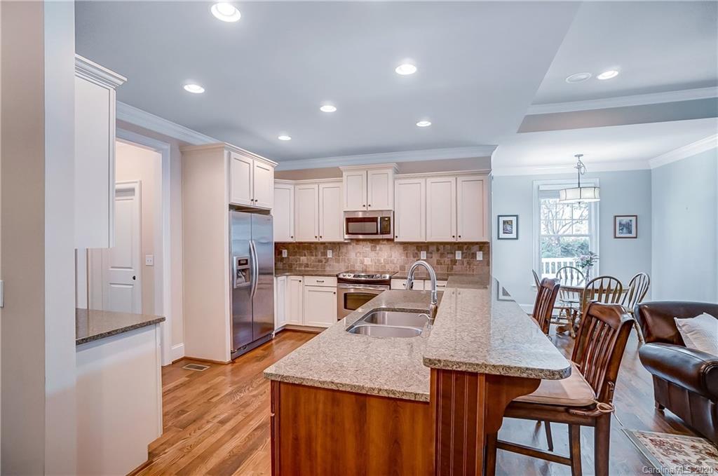 694 Revival Row Fort Mill, SC 29708 - Photo 12 of 46 a kitchen with a table chairs refrigerator and microwave