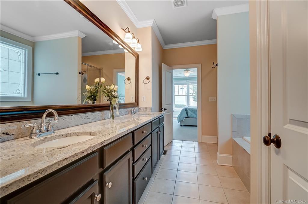 694 Revival Row Fort Mill, SC 29708 - Photo 29 of 46 a bathroom with a granite countertop sink a mirror and a