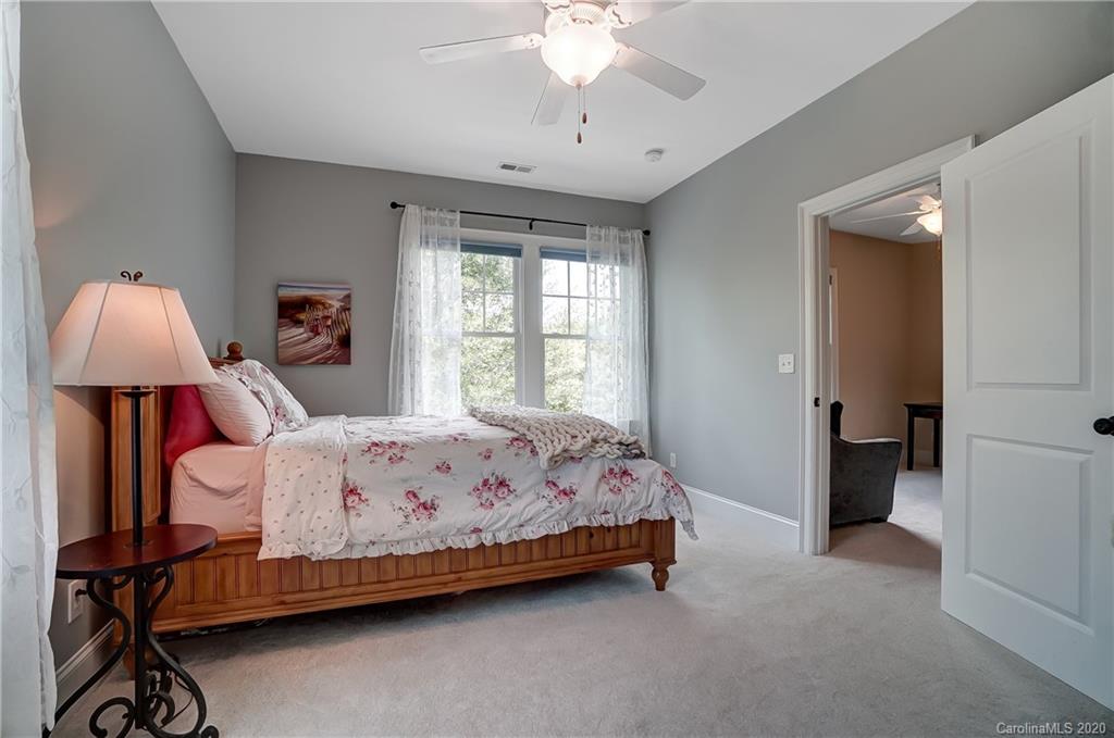 694 Revival Row Fort Mill, SC 29708 - Photo 33 of 46 a bedroom with a bed and a chandelier