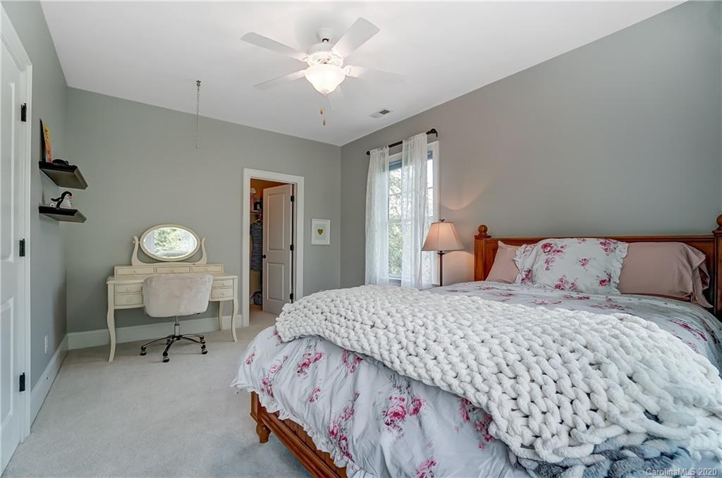 694 Revival Row Fort Mill, SC 29708 - Photo 35 of 46 a bedroom with a bed and a lamp