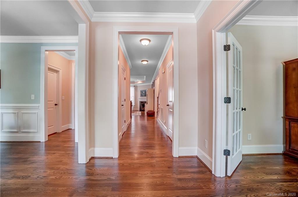 694 Revival Row Fort Mill, SC 29708 - Photo 5 of 46 a view of a hallway with wooden floor and a living room