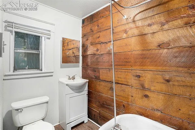 a white toilet sitting next to a bathroom sink
