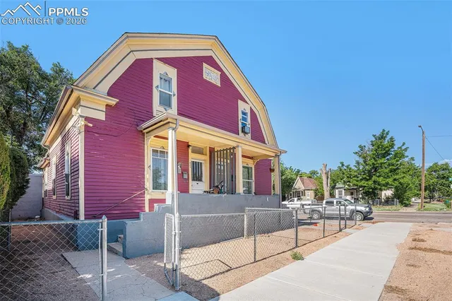 a view of a brick building with a bench in front of building