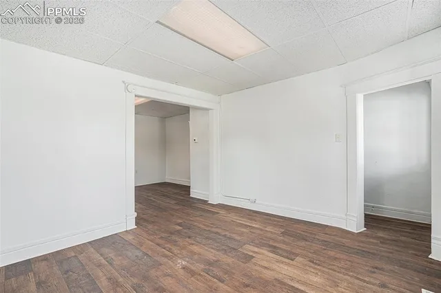 an empty room with wooden floor & closet