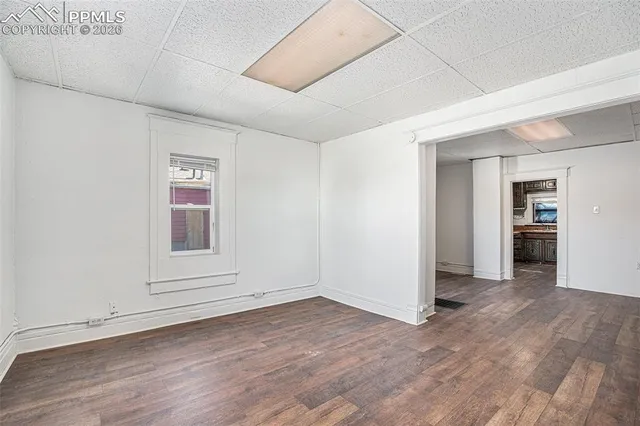 an empty room with wooden floor and closet