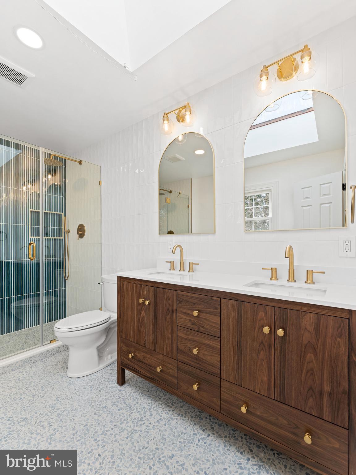 972 Roeloffs Road Yardley, PA 19067 - Photo 31 of 64 a bathroom with a toilet a double vanity sink and a mirror