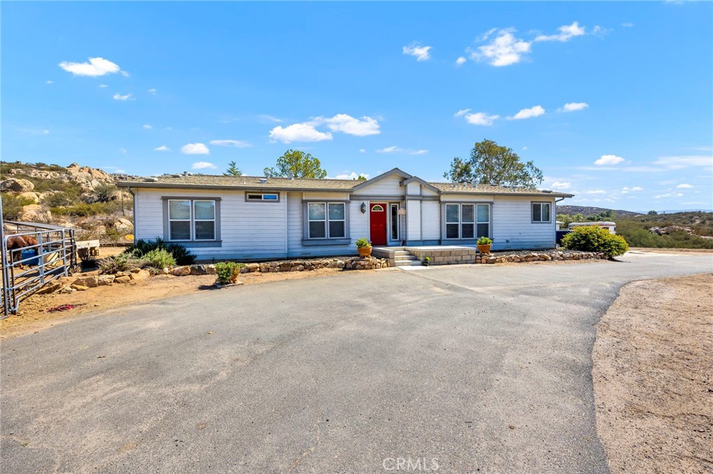35125 Stirrup Road Temecula, CA 92592 - Photo 1 of 51 a view of a house with a patio and a yard