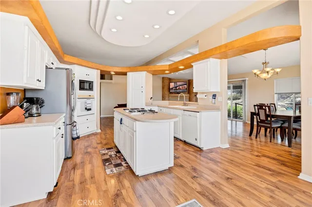 a large kitchen with a large counter top appliances and cabinets