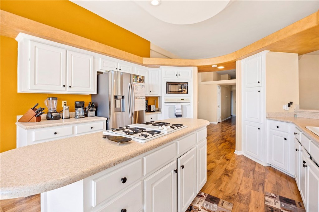 35125 Stirrup Road Temecula, CA 92592 - Photo 13 of 51 a kitchen with stainless steel appliances granite countertop a refrigerator and a stove top oven