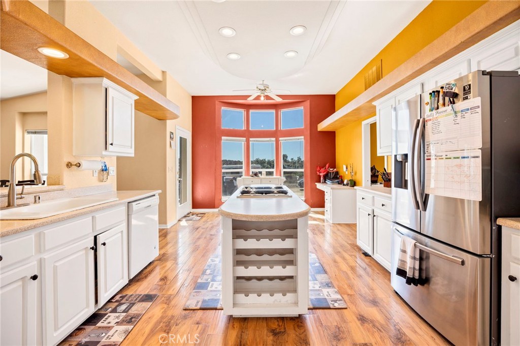 35125 Stirrup Road Temecula, CA 92592 - Photo 14 of 51 a large kitchen with kitchen island a large window a sink and stainless steel appliances