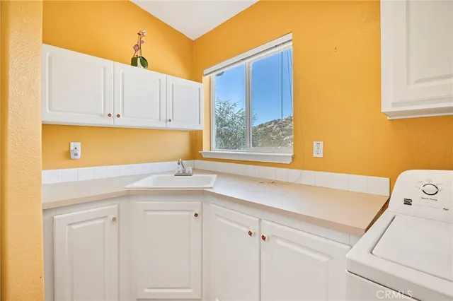 a kitchen with a sink and cabinets
