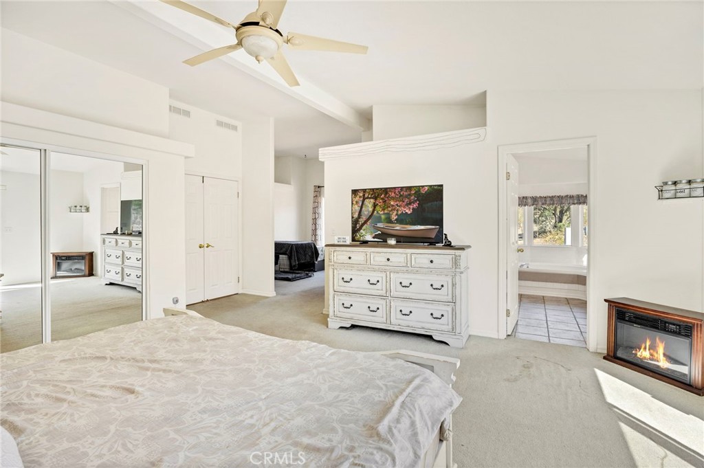 35125 Stirrup Road Temecula, CA 92592 - Photo 22 of 51 a bedroom with a bed and a flat tv screen on dresser