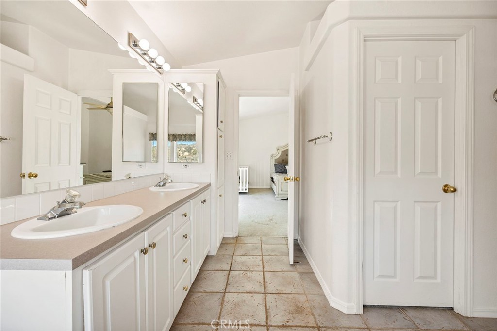 35125 Stirrup Road Temecula, CA 92592 - Photo 25 of 51 a spacious bathroom with a double vanity sink and a mirror