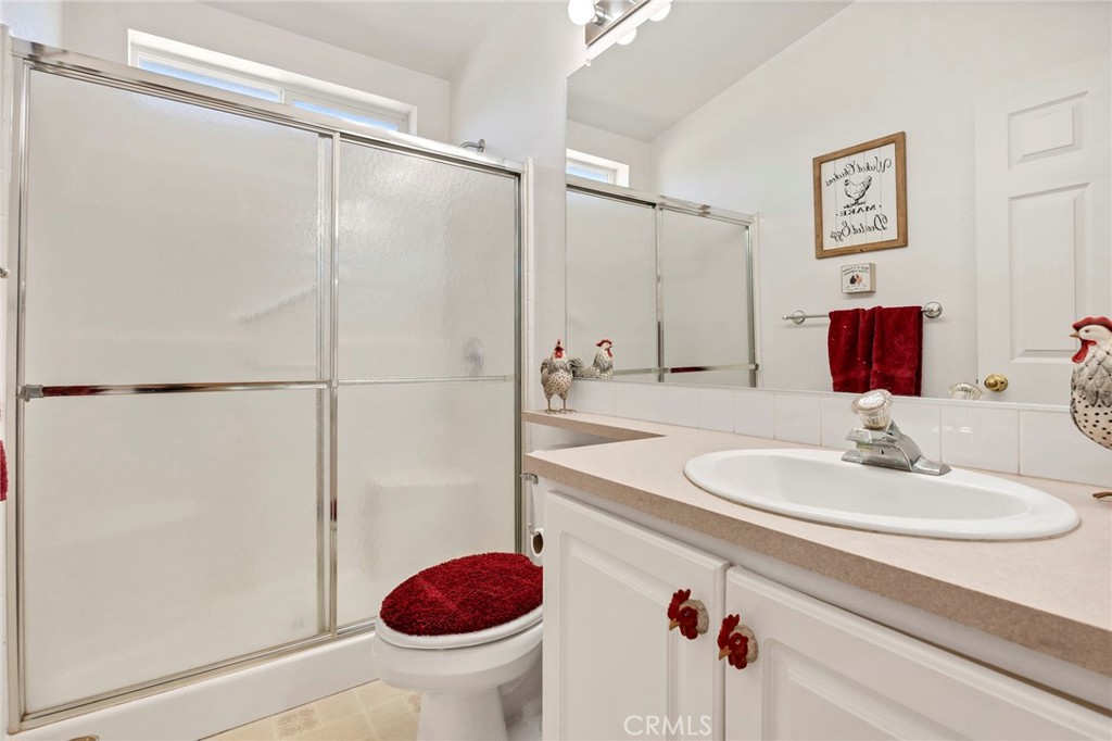 35125 Stirrup Road Temecula, CA 92592 - Photo 28 of 51 a bathroom with a sink toilet and shower