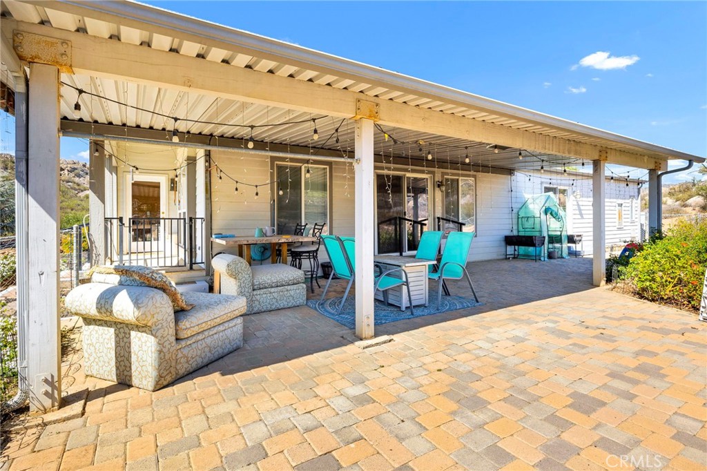 35125 Stirrup Road Temecula, CA 92592 - Photo 29 of 51 a view of a patio with table and chairs